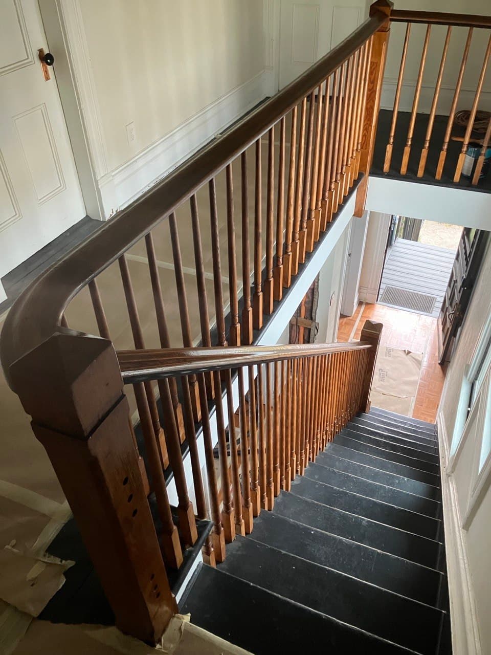 Remodeled historic staircase — restained turned balusters, refinished handrail, and dark-painted treads by Stumptown Stairs, Portland, OR